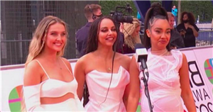 Little Mix’s Leigh-Anne Pinnock and Perrie Edwards cradle baby bumps in all white as they walk the red carpet at The Brit Awards