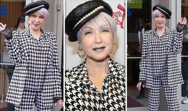 Cyndi Lauper, 69, hasn’t aged a day as she dons houndstooth suit and purple lipstick