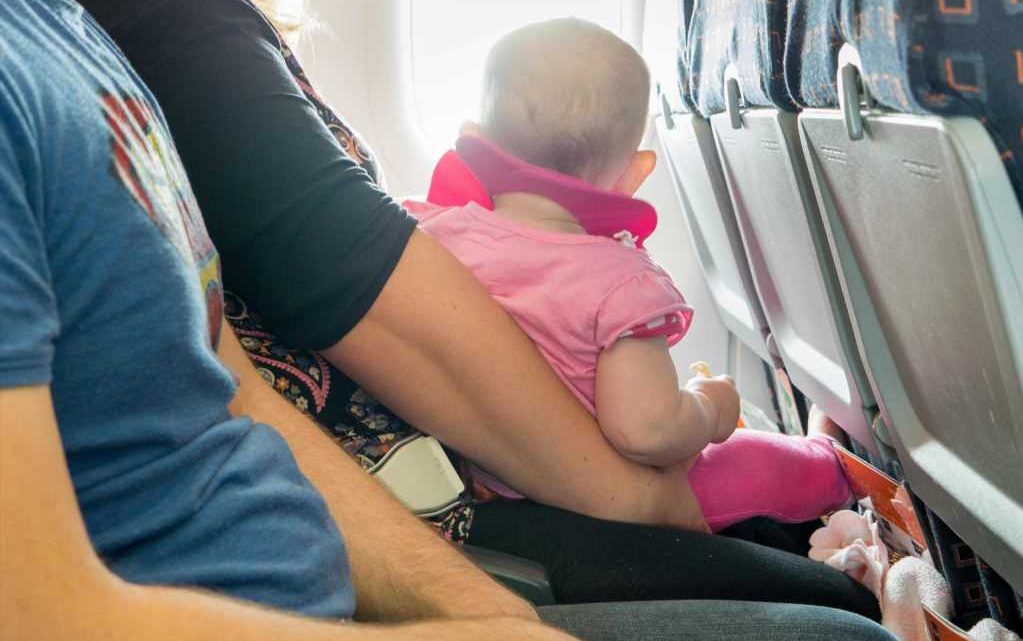 Angry father slams flight attendant for refusing to let his baby sit in empty seat | The Sun